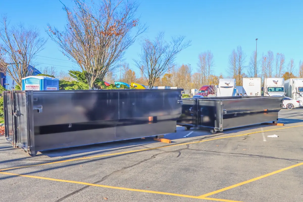 Professional dumpster rental service with roll-off container on residential driveway in Smiths Station